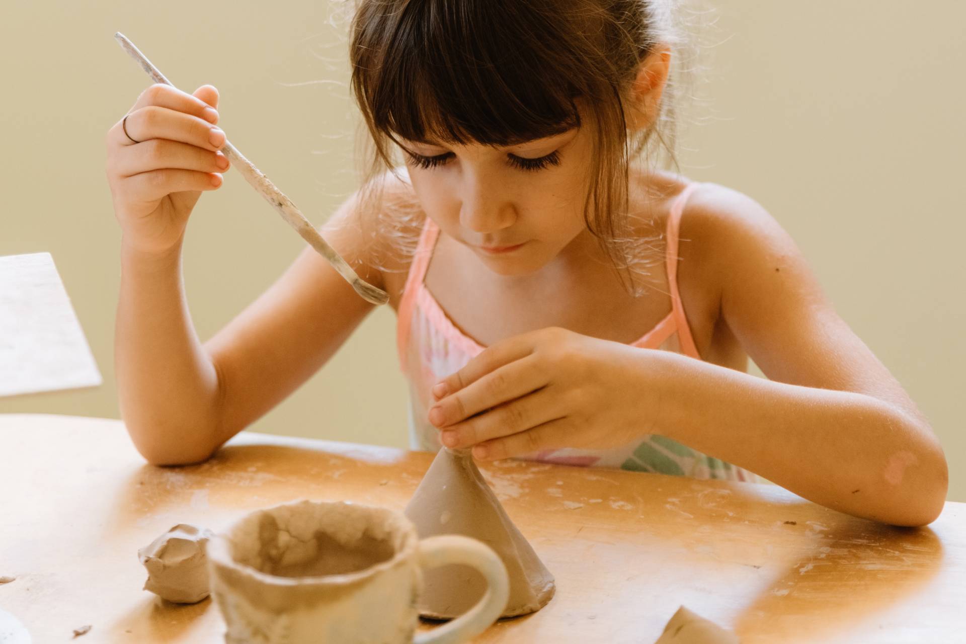 concentrated-girl-making-doll-in-pottery-workshop-2026-03-13-04-20-50-utc-w